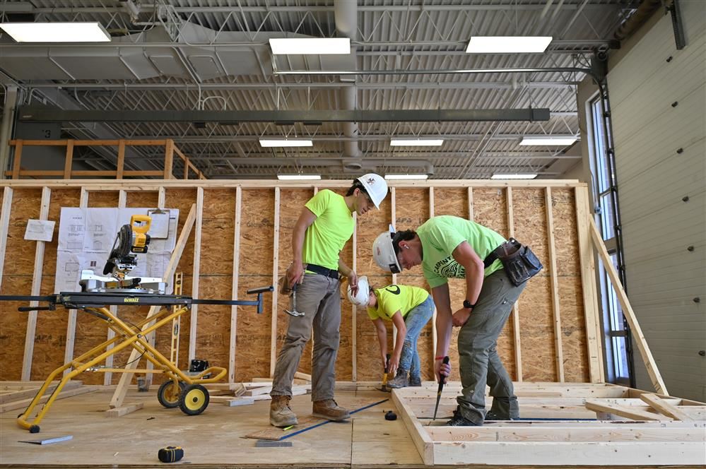 Students build a structure together. Students build a structure together.