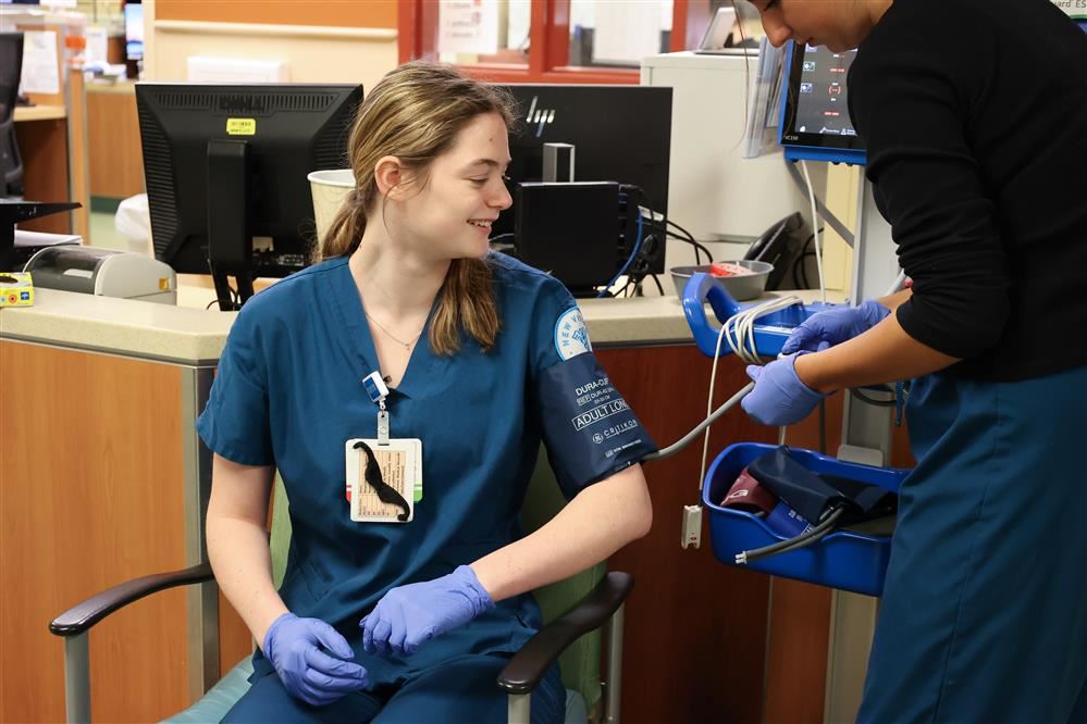 New Vision Medical Careers student checks hospital monitor New Vision Medical Careers student checks hospital monitor