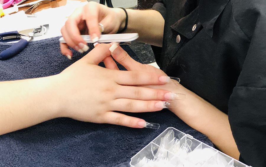 EMCC student filing a client's nail EMCC student filing a client's nail