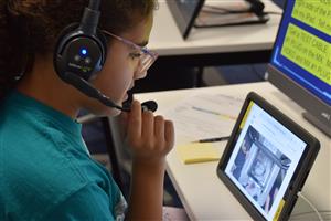 student speaking on a headset