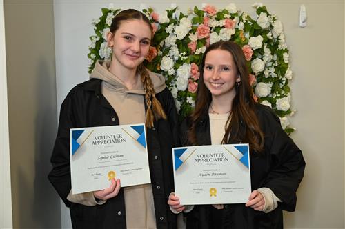 Sophie and Ayden posing with their certificates.