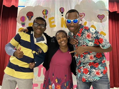 Three Creekside Students pose on stage before the fashion show.