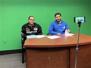  Two Creekside News Club students record their video game review.