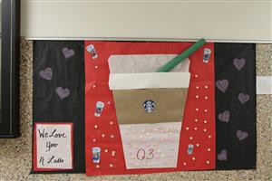 Valentine's Day design exclaims "We love you a latte" with a picture of a Starbucks latte.