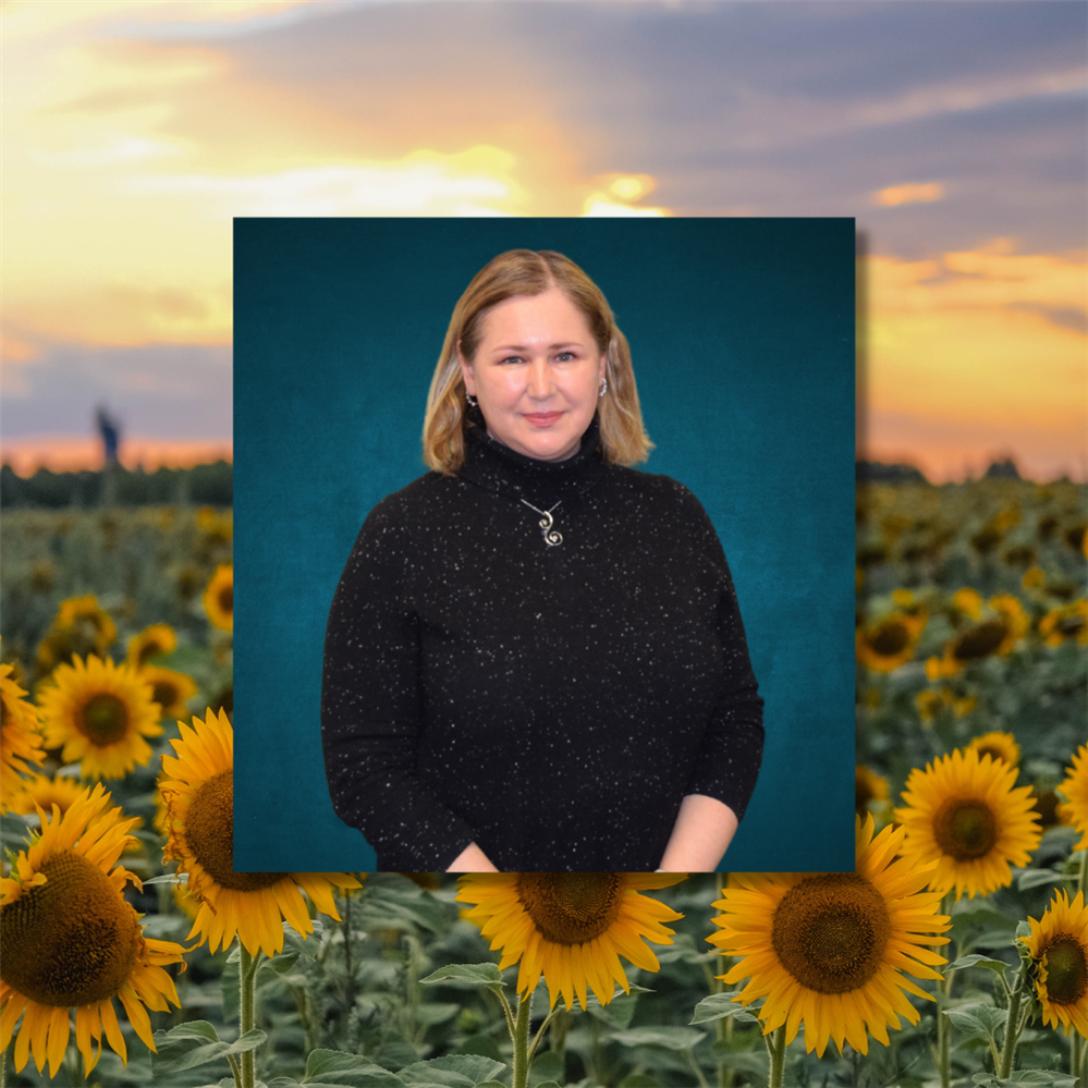  photo of svetlana smiling over the background of sunflowers